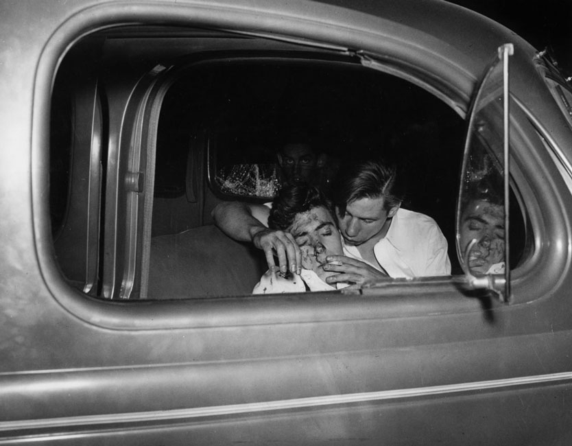 Weegee: Young Man Smoking a Cigarette After a Car Crash