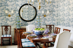 The dining room was designed around a table and chairs that belonged to the wife’s mother and her grandmother’s sideboard. The wallcovering is by Scalamandre, the rug is from Fibreworks and the chairs are covered in an Anna French fabric. CR Laine upholstered chairs sit beneath lighting from Visual Comfort. 