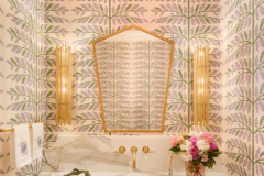 Schumacher wallcovering and lighting by Arteriors create a jewel box of a powder room. The vanity by LSM Interior Design was fabricated by Precision Installations. Marble countertop from Premier Granite and Stone. 