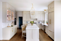 Brookside Lumber cabinetry and quartz countertops from Premier Granite and Stone were used in the kitchen. Woodbridge Furniture counter stools are covered in fabric from Thibaut. 