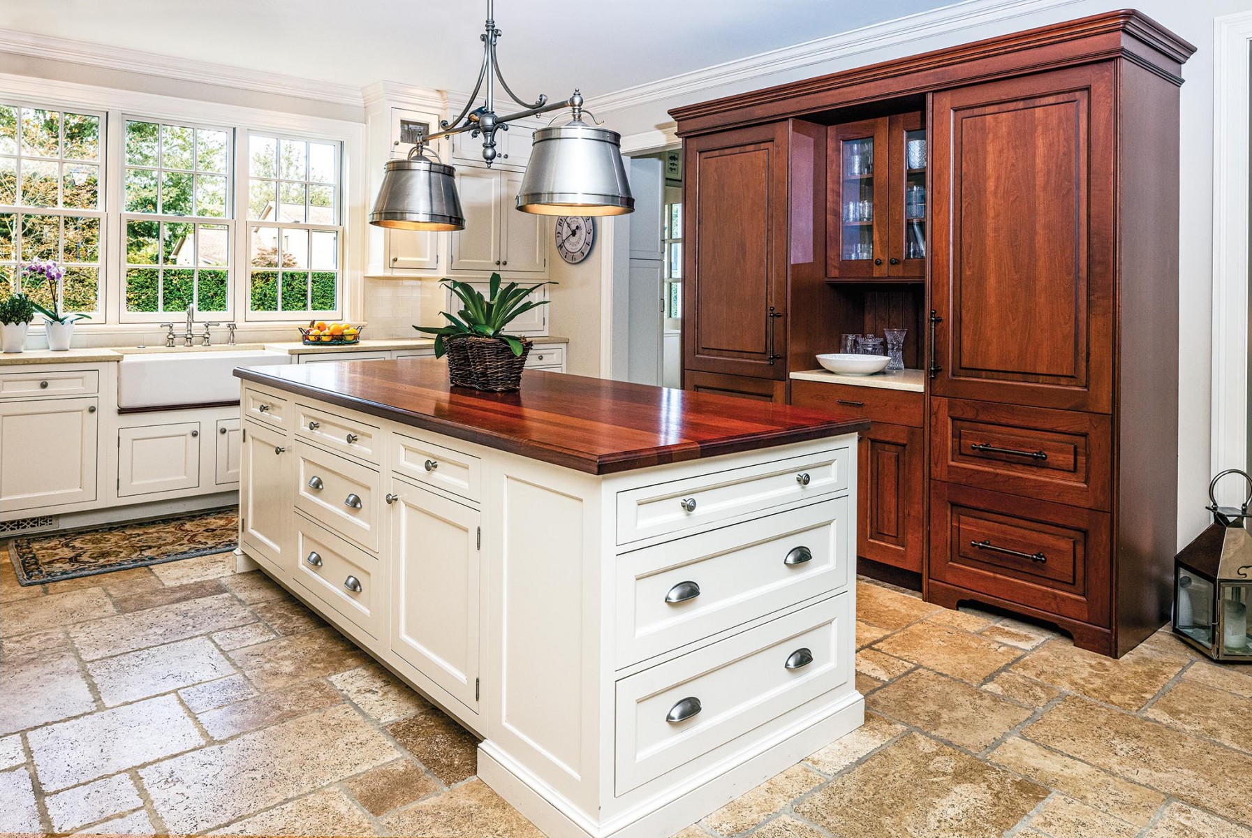 Kitchen Charm:
The island by Wood-Mode is the centerpiece of the kitchen, with a light fixture by Visual Comfort.