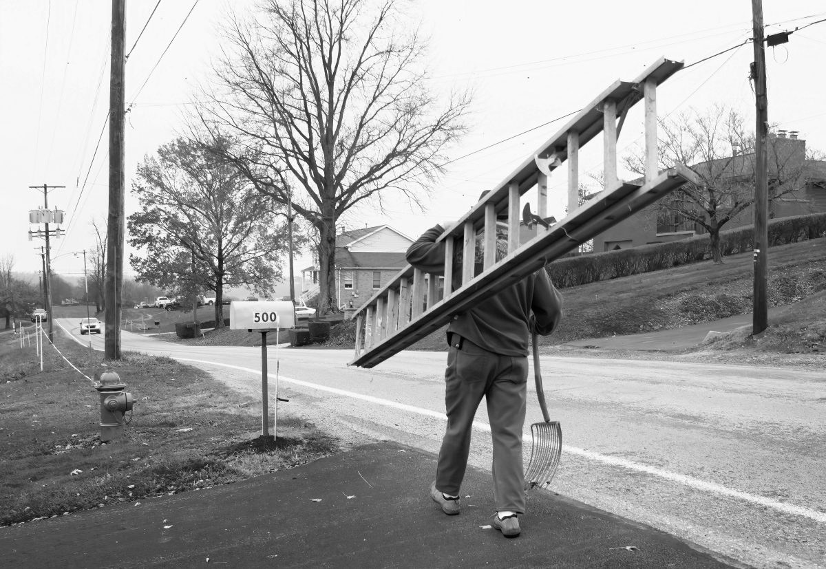 Willie Slebodnik carries a ladder and pitchfork his son, Dan Slebodnik,  purchased at the Ritter Farm auction. Dan Slebodnik said they will be used at their farm in Gibsonia.